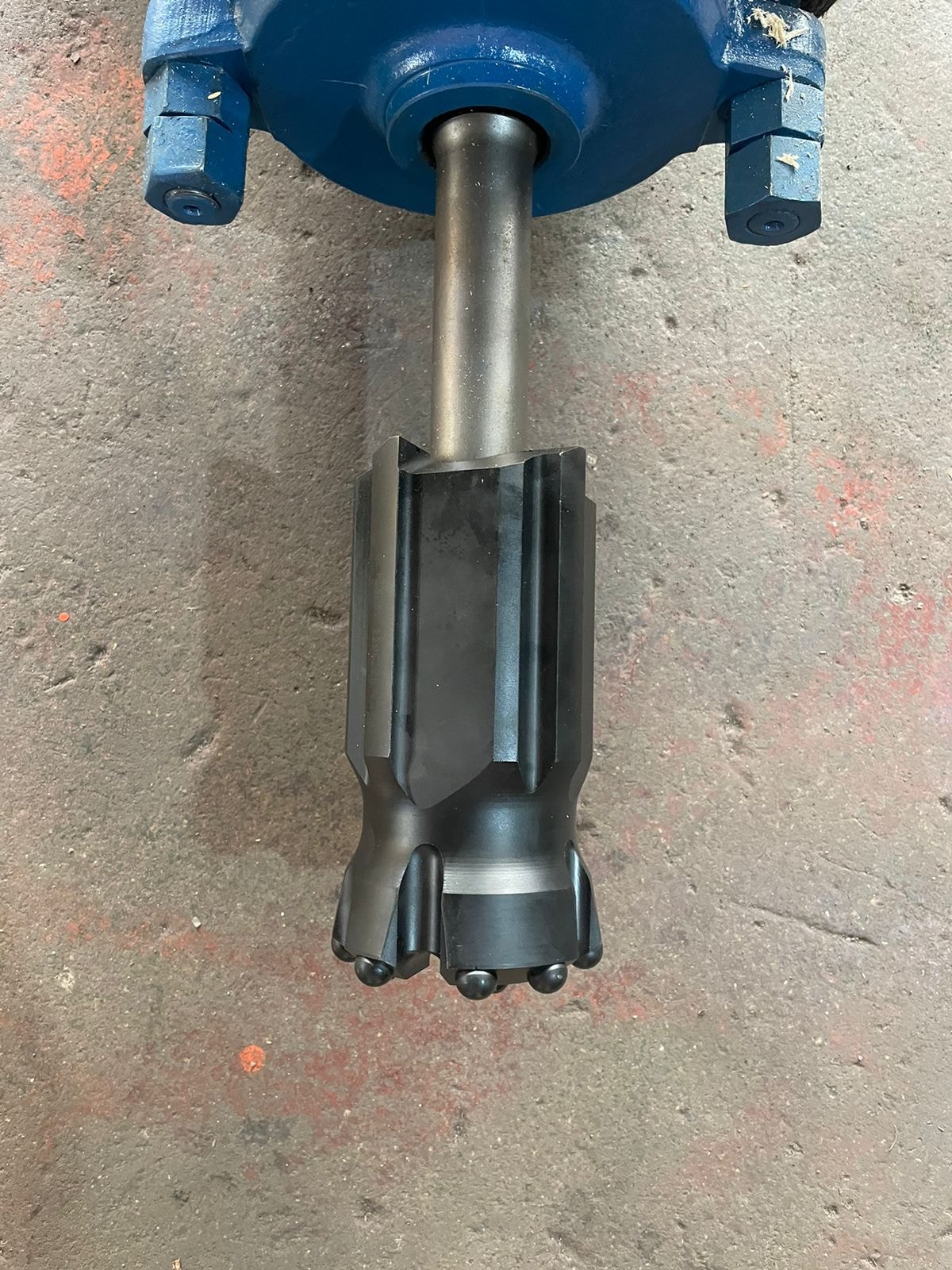 Hydraulic drifter with cross-cut drill bit fitted — ready for deployment