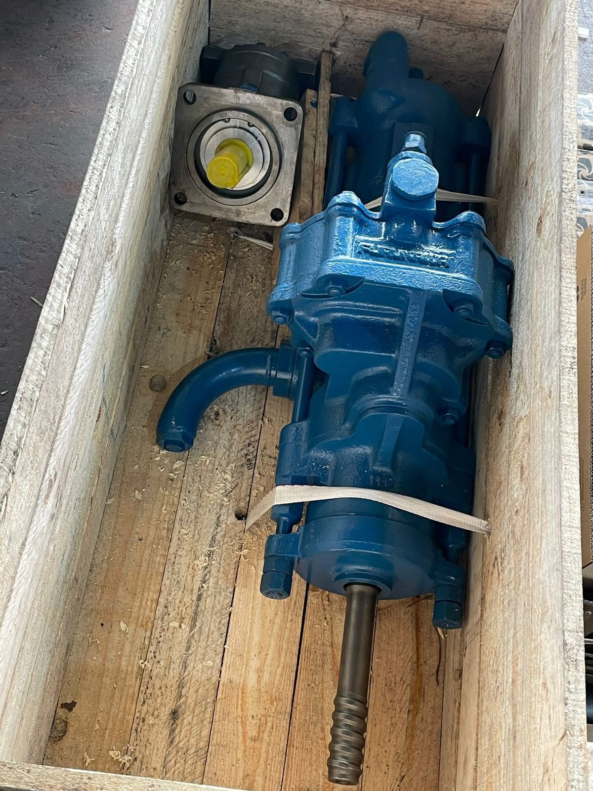 Overhauled hydraulic drifter and motor packaged in wooden crate for shipping