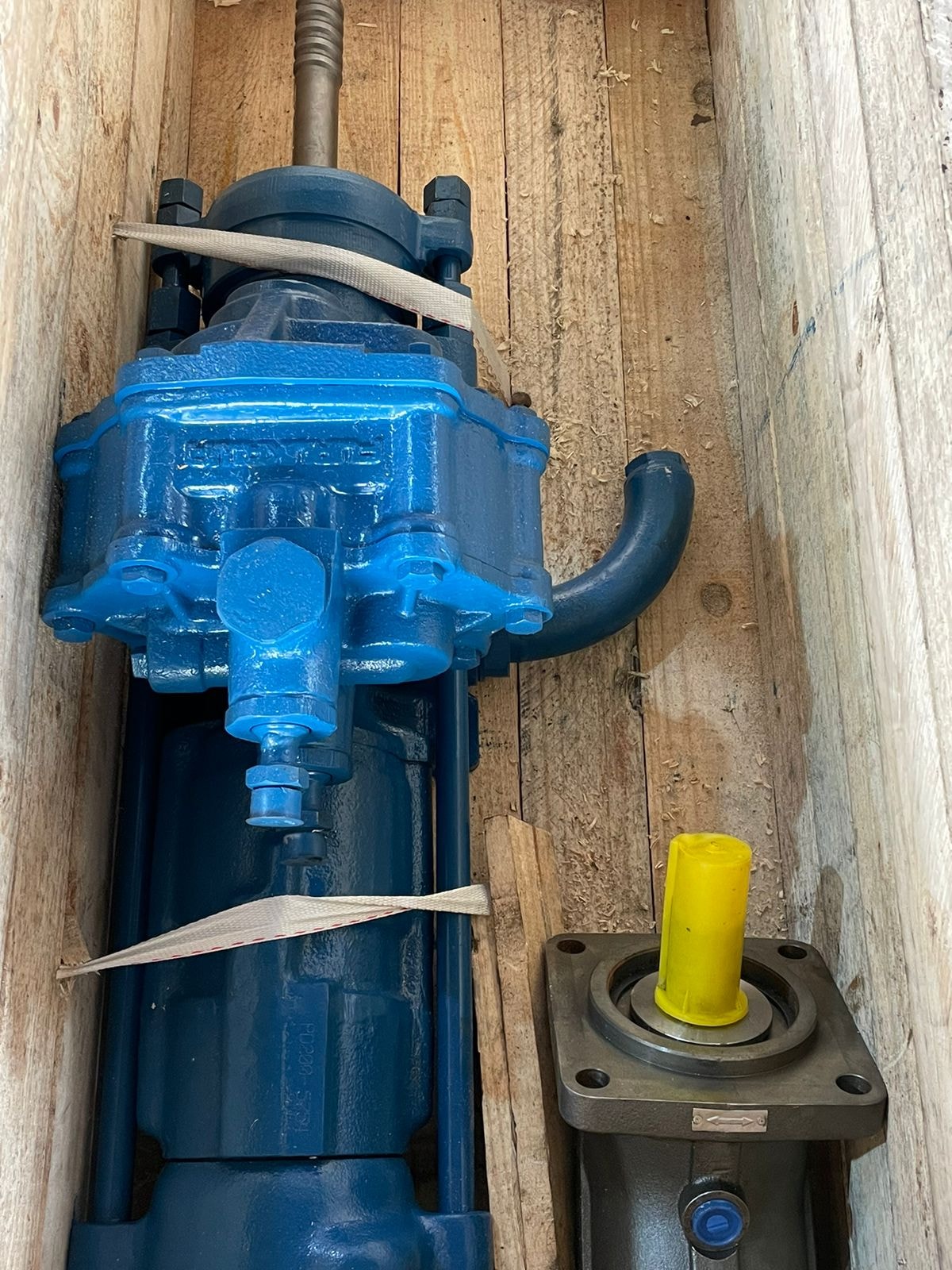 Hydraulic drifter close-up in shipping crate with hydraulic motor